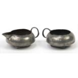 Archibald Knox for Liberty & Co, Arts & Crafts pewter milk jug and handled sugar bowl, each numbered