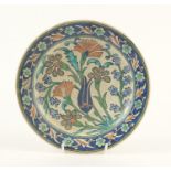 Islamic Iznik pottery plate hand painted with flowers, 22.5cm in diameter