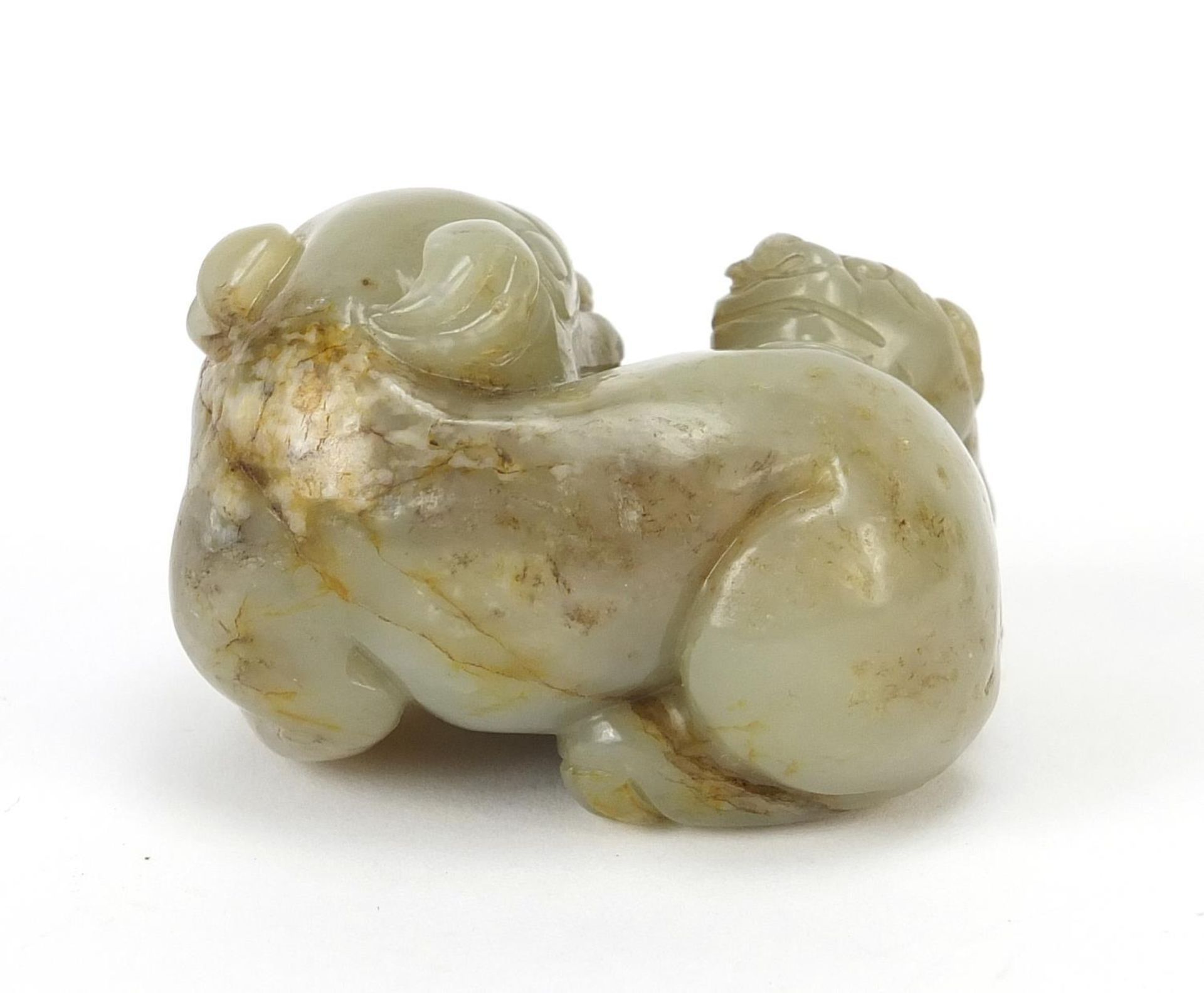 Chinese celadon and russet jade carving of two mythical lions, 6cm wide - Image 3 of 6