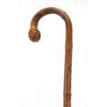 Good Chinese bamboo walking stick finely carved with two monkeys chasing a serpent catching a
