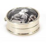 Circular silver pill box, the hinged lid enamelled with Charlie Chaplin, 3cm in diameter, 15.8g