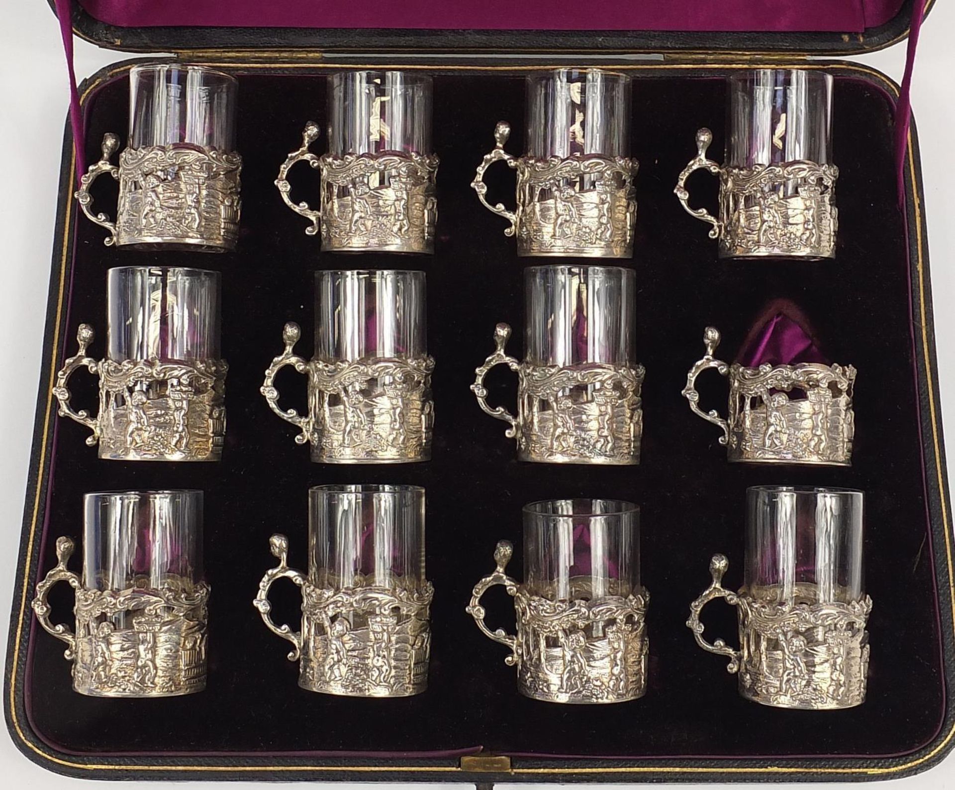 Set of twelve Victorian silver glass holders embossed with cherubs at play and fitted with eleven - Image 2 of 5