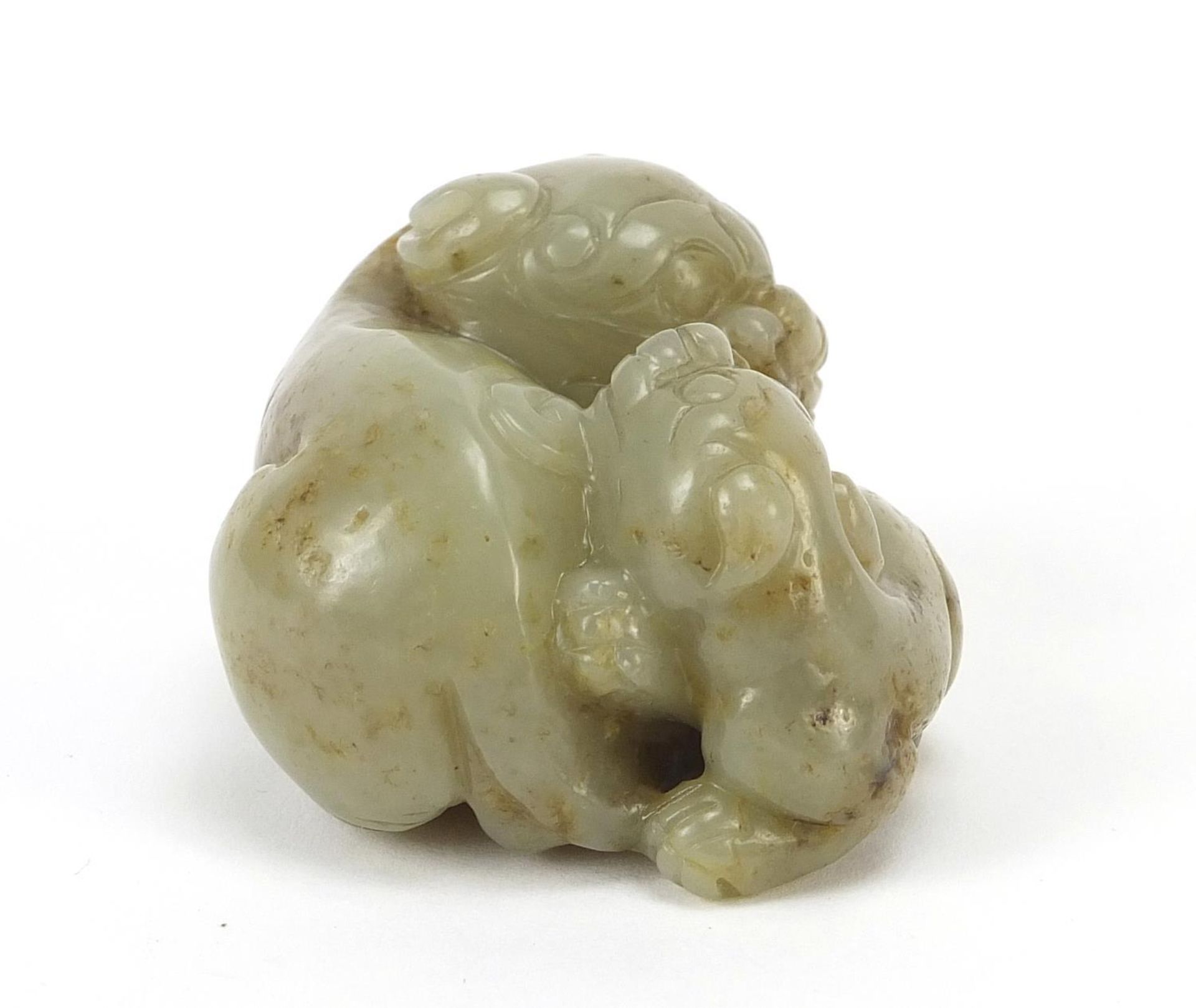 Chinese celadon and russet jade carving of two mythical lions, 6cm wide - Image 4 of 6