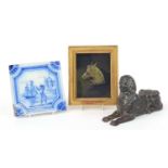 Cast iron Sphynx, bronzed horse head plaque housed in a glazed frame and a Delft style tile