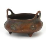 Chinese patinated bronze tripod censer with twin handles, 8cm in diameter