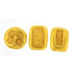 Three Chinese gold coloured metal ingots, the largest 3.5cm wide