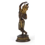 Tibetan partially gilt bronze figure of a semi nude deity, 20.5cm high