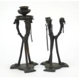Pair of patinated bronze classical candlesticks with dog's heads
