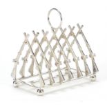 Military interest silver plated toast rack in the form of rifles, 11.5cm in length