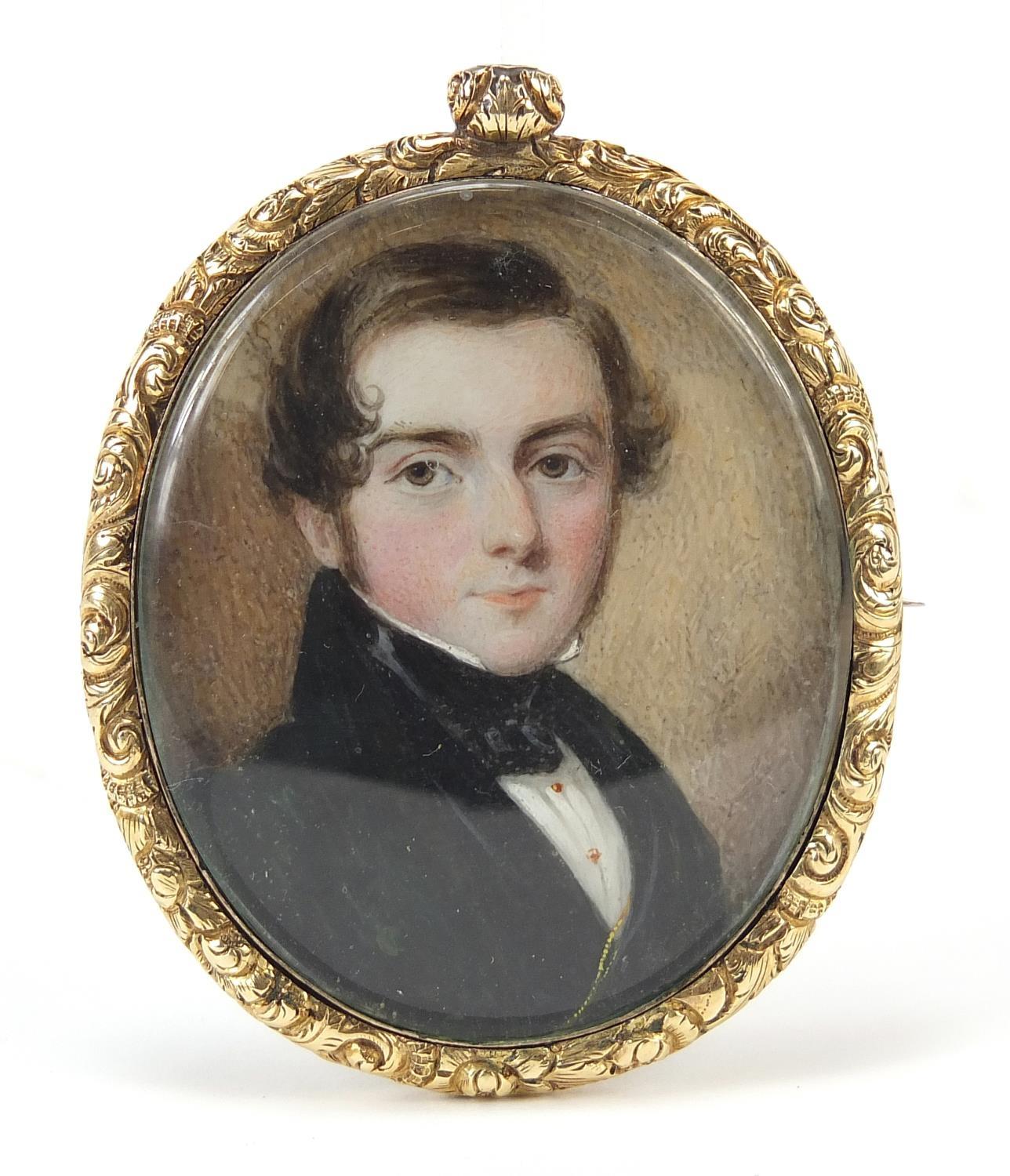 Georgian oval hand painted portrait miniature of a young gentleman housed in a gold coloured metal