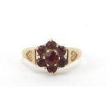 9ct gold garnet flower head ring, size K, 2.0g