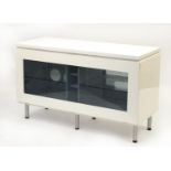 White high gloss multi media stand with smoked glass drop down front, 66cm H x 110cm W x 44cm D