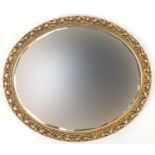 Oval gilt framed mirror with bevelled edge, 68.5cm x 59cm