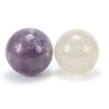 Two fortune teller's crystal balls including an amethyst example, the largest 10.5cm in diameter