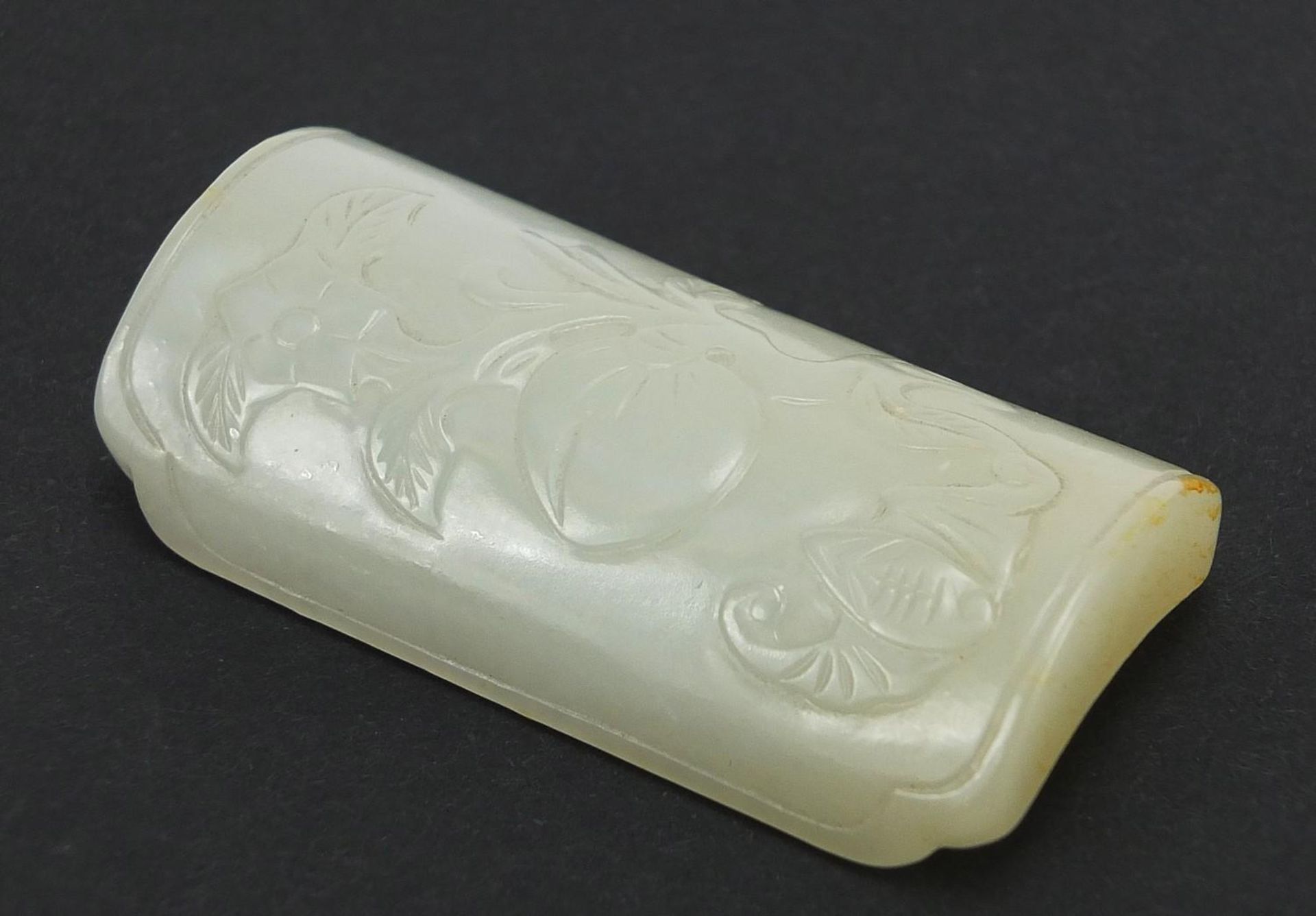 Chinese pale green jade scholar's wrist rest carved with a bat and peach, 6cm wide