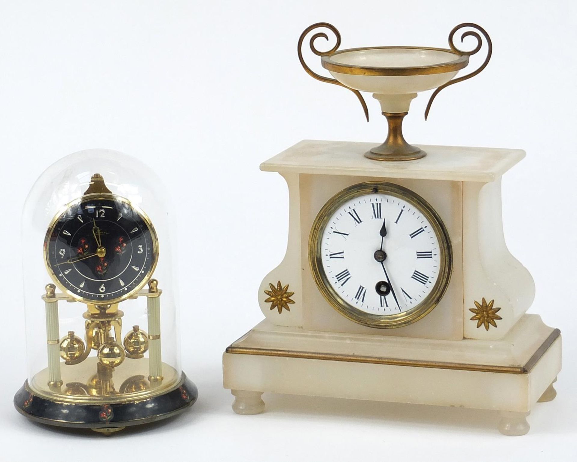 German brass anniversary clock and alabaster mantle clock with enamel dial, the largest 25.5cm high