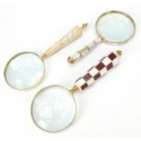 Three magnifying glasses with mother of pearl chequered design handles, the largest 26.5cm in length