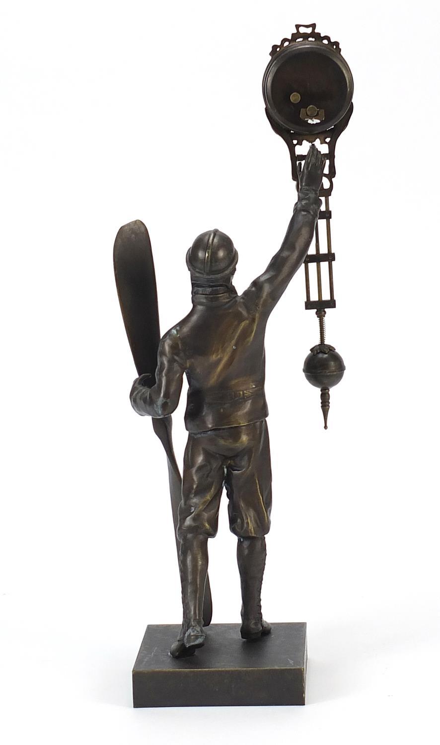 Military interest patinated bronze mystery clock in the form of a pilot holding a propeller, 38cm - Image 2 of 4