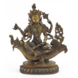 Chino Tibetan patinated bronze figure of Buddha on mythical animal, 25.5cm high