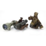 Three military interest optical instruments, the largest 22.5cm wide