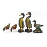 Two pairs of hand painted carved wood ducks and a cast iron duck doorstop, the largest each 37.5cm