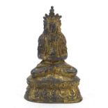 Chino-Tibetan partially bronze figure of seated Buddha, 15cm high