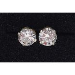 Pair of 14ct gold diamond solitaire earrings, each approximately 5.5mm in diameter x 3.5mm deep