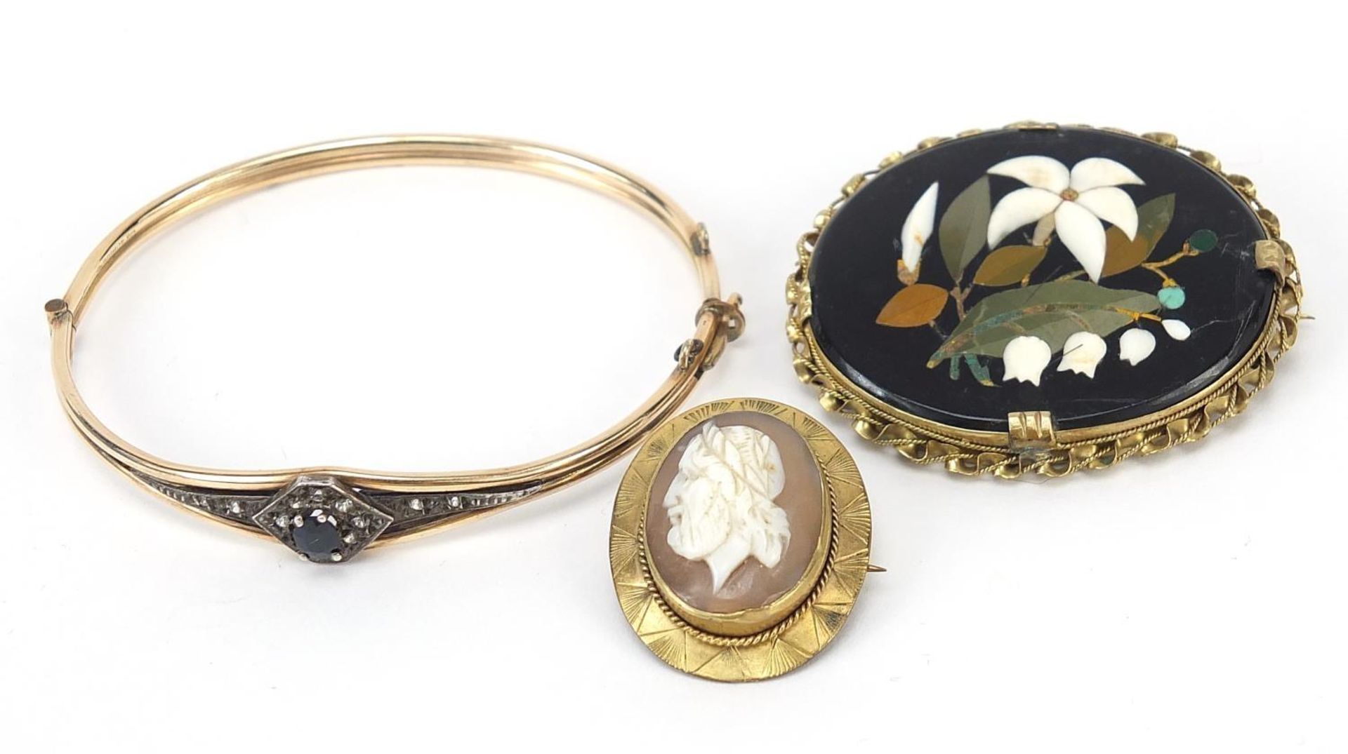 Antique jewellery comprising a pietra dura brooch, cameo brooch and a black and clear sapphire