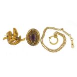 Gold coloured metal jewellery including a Victorian brooch set with a purple stone and a watch