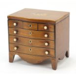 Victorian inlaid mahogany tea caddy in the form of a serpentine fronted six drawer chest, 17cm H x
