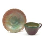 Galileo Chini, Italian pottery cup and saucer having a green and red marbleised glaze, the saucer