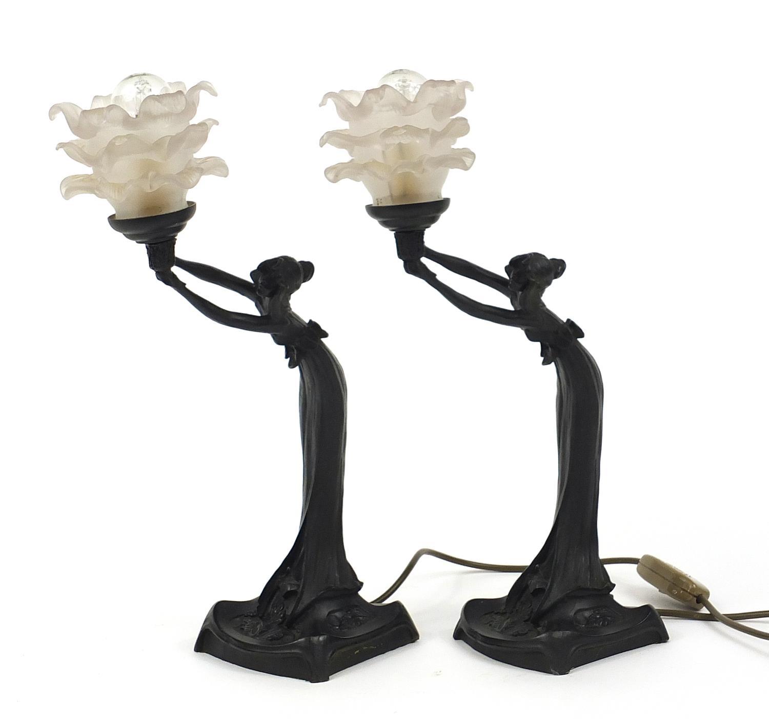 Pair of Art Nouveau style maiden design table lamps each with frosted frilled glass shades, 44cm