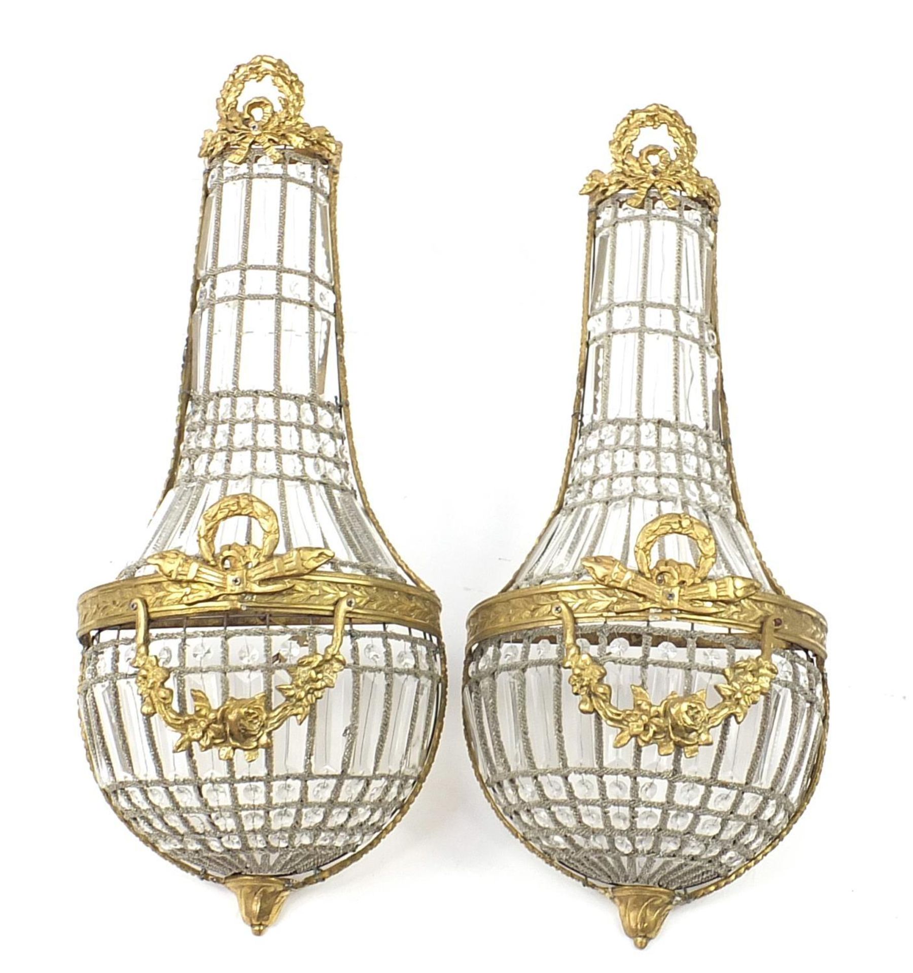 Pair of ornate gilt metal chandelier design wall sconces with bow design, each 71cm high