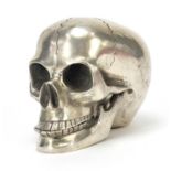 Silver coloured metal skull with articulated jaw, 12cm in length