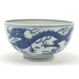 Chinese blue and white porcelain bowl hand painted with a dragon and phoenix amongst clouds