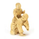 Japanese carved ivory okimono of a father and child playing, 11.5cm high
