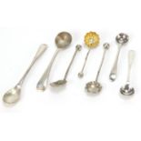 Seven silver mustard spoons including two with shell shaped bowls, various hallmarks, the largest