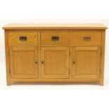 Contemporary light oak sideboard fitted with three drawers above cupboard doors, 81cm H x 135cm W