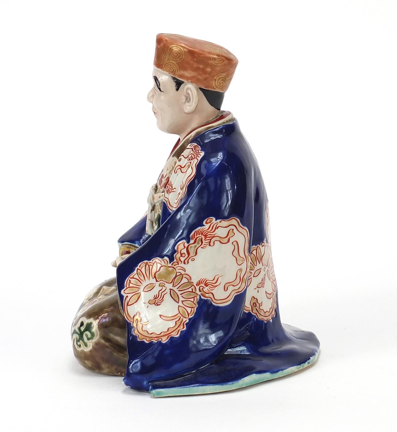 Japanese porcelain figure of a seated robed man, 17cm high - Image 3 of 7