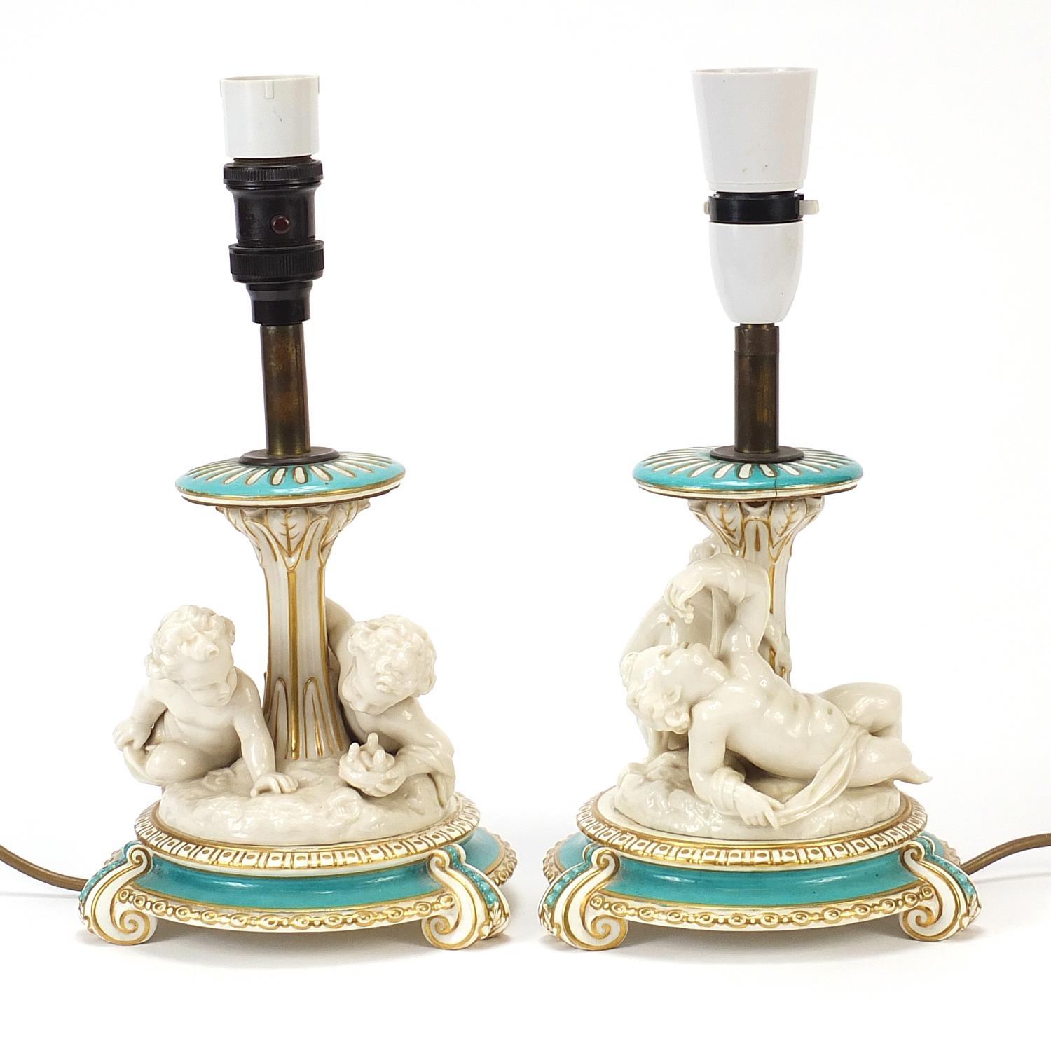 Pair of 19th century turquoise ground porcelain Putti design table lamps, each overall 30.5cm high