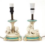 Pair of 19th century turquoise ground porcelain Putti design table lamps, each overall 30.5cm high