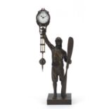 Military interest patinated bronze mystery clock in the form of a pilot holding a propeller, 38cm
