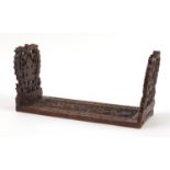 Anglo Indian hardwood extending book slide profusely carved with leaves and berries, 40cm wide