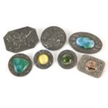 Seven Arts & Crafts brooches including one with sterling silver front and Ruskin type panels, the