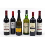 Six bottles of alcohol including Graham's Extra Dry port, Prosecco and Medoc red wine