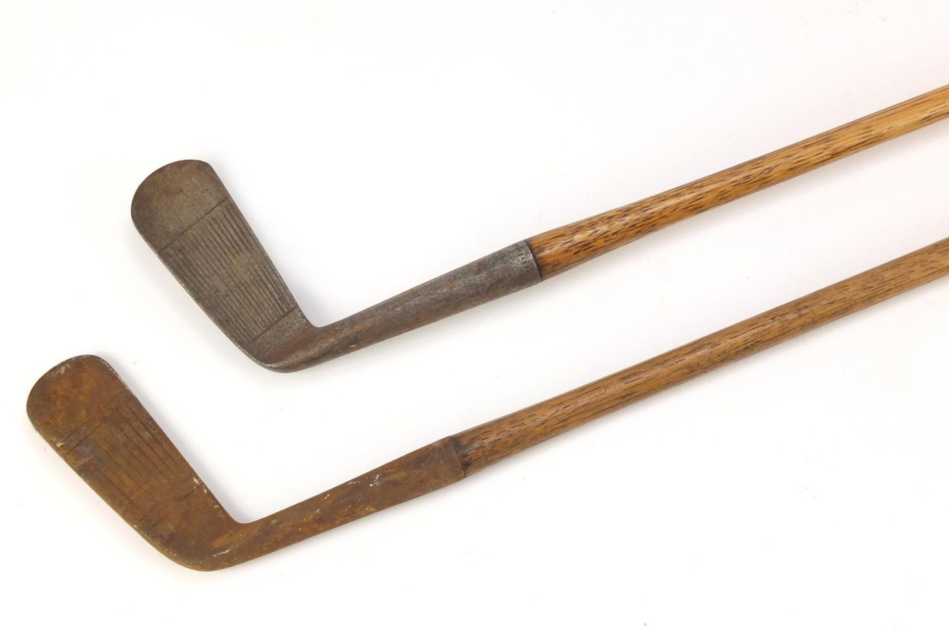 Two wooden shafted putters including one by H E Pearse, the largest 89cm in length