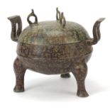 Chinese verdigris patinated bronze archaic type three footed vessel and cover with twin handles,