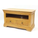 Contemporary light oak multi media stand with open shelf above two drawers, 61cm H x 104cm W x