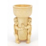 Carved bone Putti design candleholder, 8.5cm high