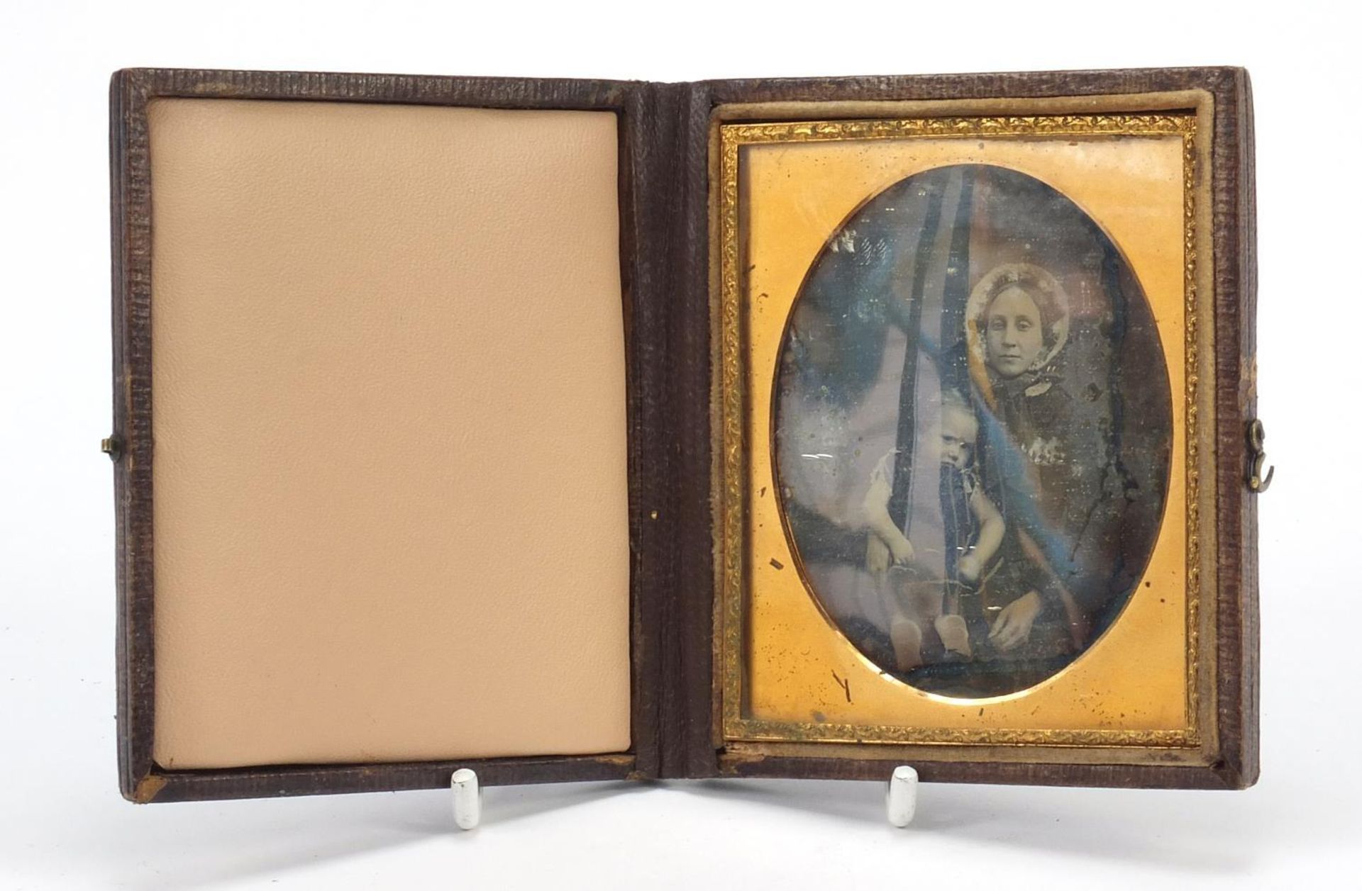 19th century daguerreotype of a mother and child housed in a tooled leather case, 9.5cm x 8.5cm